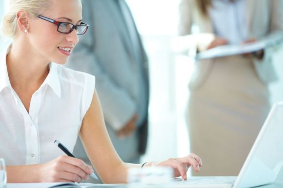 17380958 - portrait of busy secretary typing in working environment